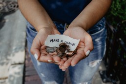 hands holding change with a note saying make a change