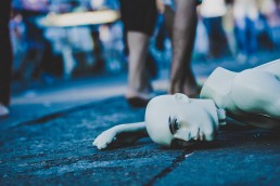 mannequin on the ground, metaphor about social responsibility by Edu Lauton